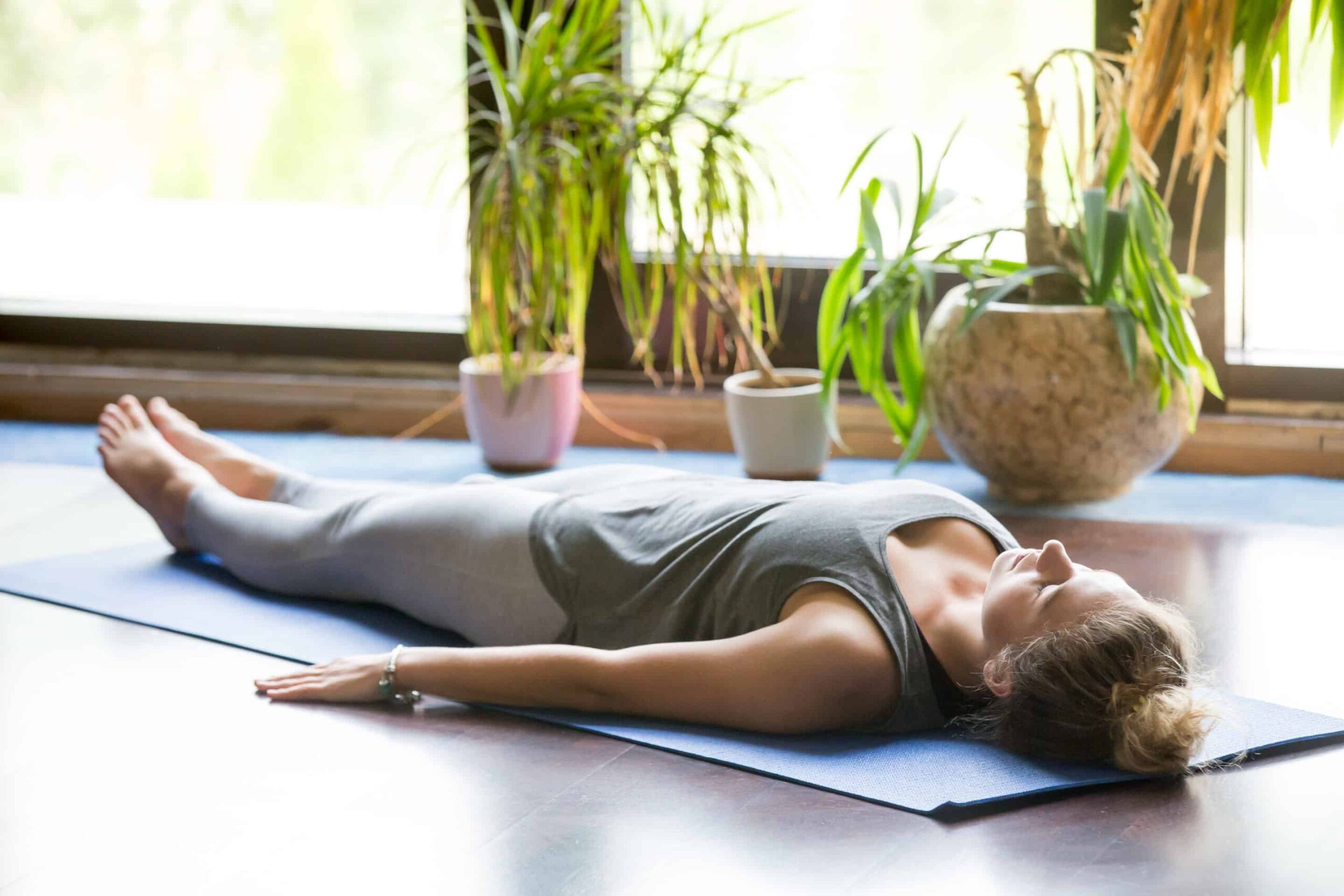 Comprehensive Yoga Nidra Scripts: Unlocking Relaxation Benefits 1 A woman practicing yoga nidra on a yoga mat scaled 1 scaled